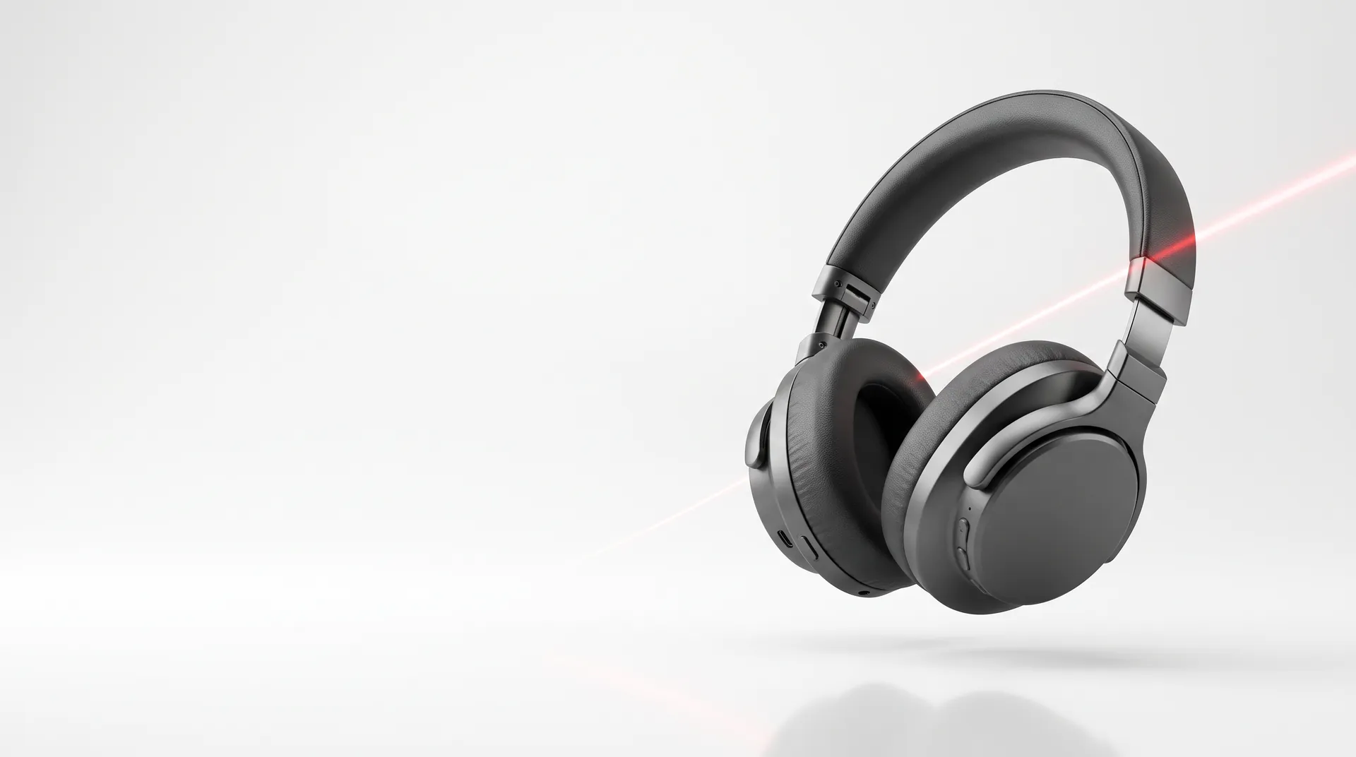 Arcus ANC headphones floating above a pale floor, crossed by a red laser line
